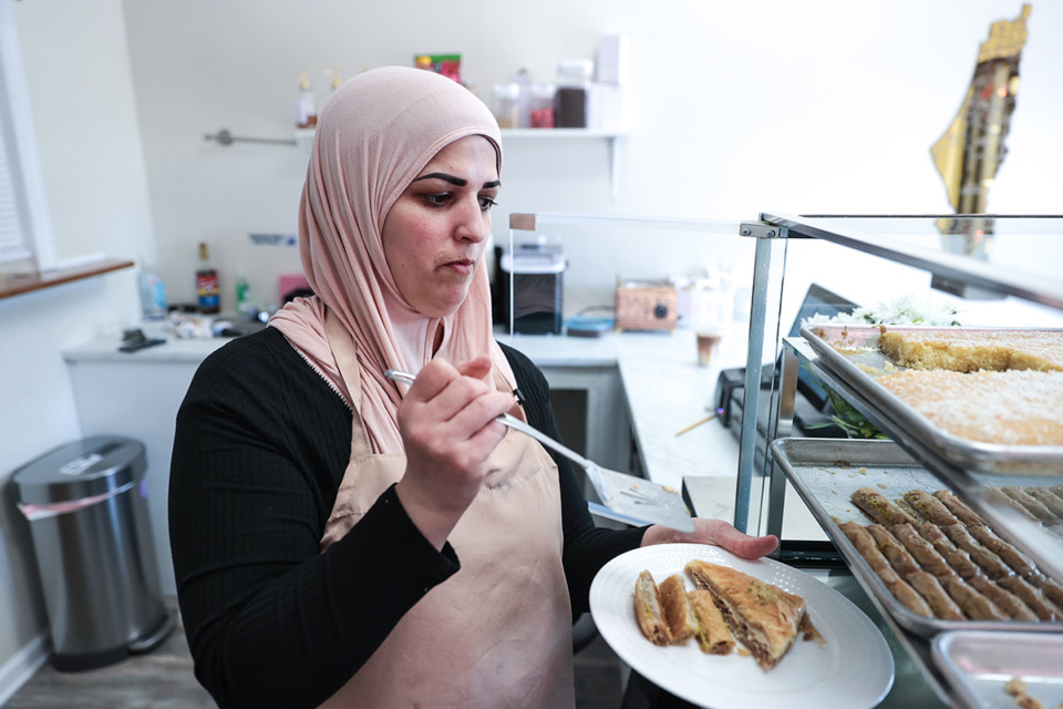 <strong>Sana Abuawad plates a batch of baklava at Sana's Sweets on Aug. 15, 2024.</strong> (Patrick Lantrip/The Daily Memphian)