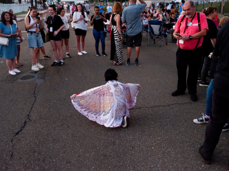 <strong>To the delight of passersby, a young Elvis tribute artist shows off his moves before the vigil.</strong> (Brad Vest/Special to The Daily Memphian)