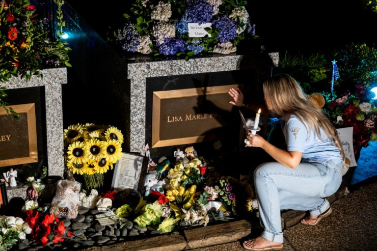 <strong>A fan brushes her hand lightly across the grave marker for Elvis&rsquo; daughter, Lisa Marie Presley, who died in January 2023 at age 54.&nbsp;</strong>(Brad Vest/Special to The Daily Memphian)