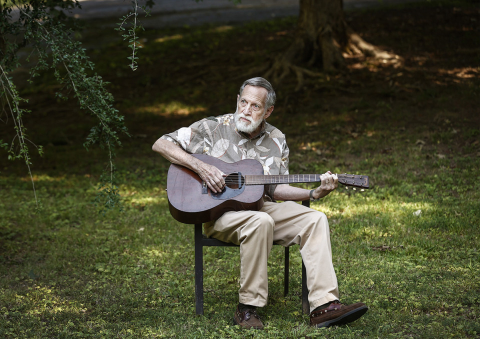 <strong>David Evans strums his guitar outside his Millington home Aug. 16.</strong> (Mark Weber/The Daily Memphian)