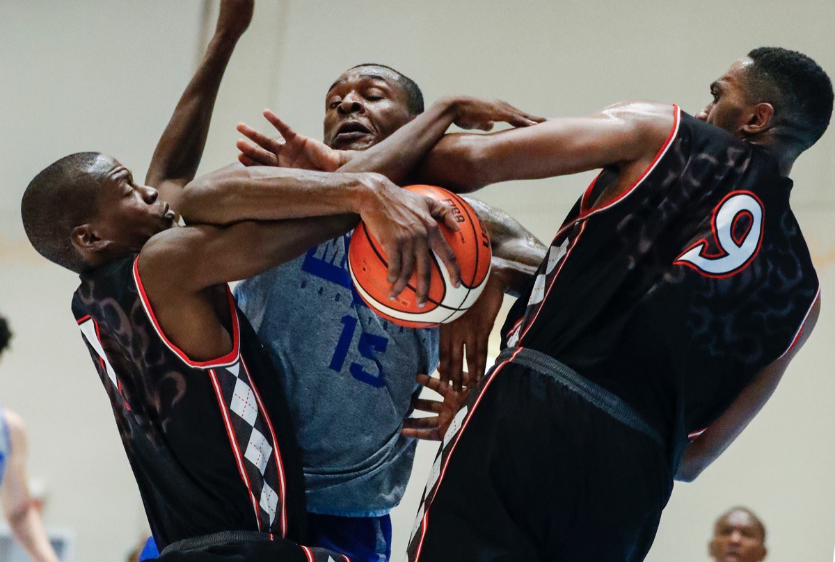 <strong>Memphis Tigers forward Lance Thomas (middle) is fouled while driving the lane against Commonwealth Bank Giants defenders Karon Pratt (left) and D&acirc;Shon Taylor (right) in the exhibition game in Nassau, Bahamas, Wednesday, Aug. 14, 2019.</strong> (Mark Weber/Daily Memphian).
