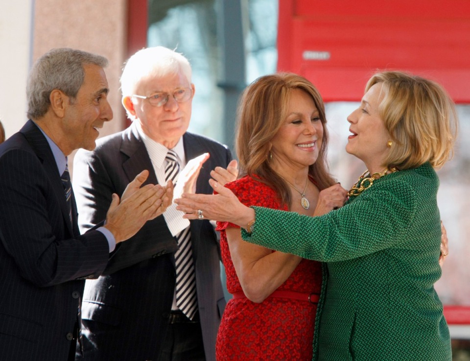 <strong>Phil Donahue joined his wife, Marlo Thomas, in Memphis at the dedication of The Marlo Thomas Center for Global Education &amp; Collaboration at St. Jude Children&rsquo;s Research Hospital in 2014. He is pictured with Thomas&rsquo; brother Tony Thomas, far left, behind his wife as former Secretary of State Hillary Rodham Clinton, far right, hugs Marlo Thomas.</strong> (Karen Pulfer Focht/AP Photo file)