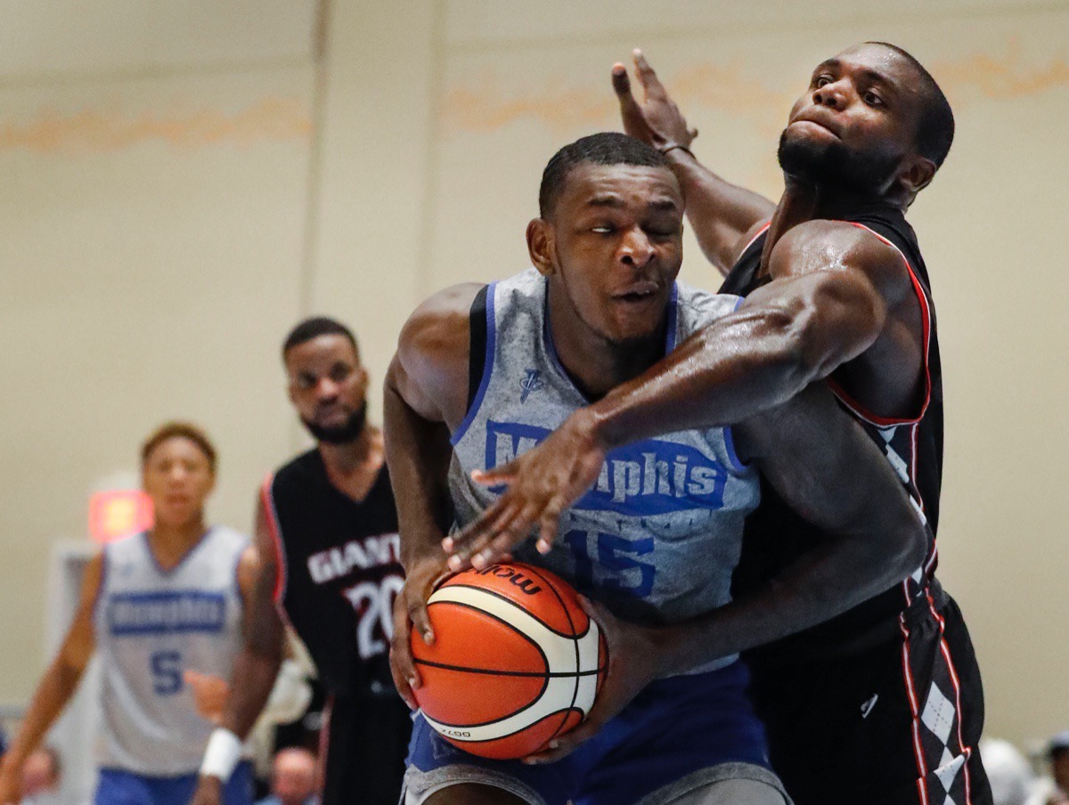 <strong>Memphis Tigers forward Lance Thomas (left) is fouled by Commonwealth Bank Giants defender Mavin Saunders (right) Wednesday.</strong>&nbsp;<strong>Coach Hardaway named him team captain before the game.</strong> (Mark Weber/Daily Memphian).
