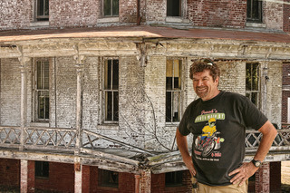 <strong>Lauren Crews in 2010 in front of the Marine Hospital nursing quarters prior to restoration.</strong> (Courtesy Lauren Crews)