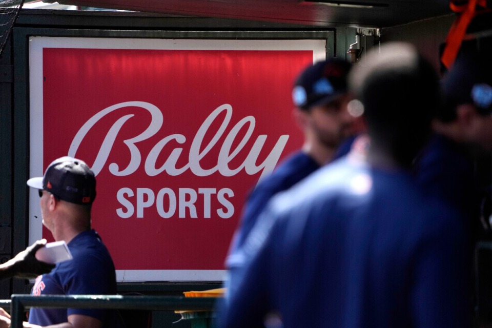 <strong>A Bally Sports sign hangs in a dugout before a spring training baseball game between the St. Louis Cardinals and the Houston Astros, March 2, 2023, in Jupiter, Florida.</strong> (Jeff Roberson/file)