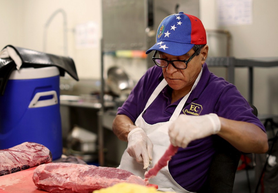 <strong>Rainier Bastardo from Venezuela slices fresh meat in preparation for the dinner rush at Global Caf&eacute; in the Crosstown Concourse.&nbsp;</strong>(Patrick Lantrip/Daily Memphian)