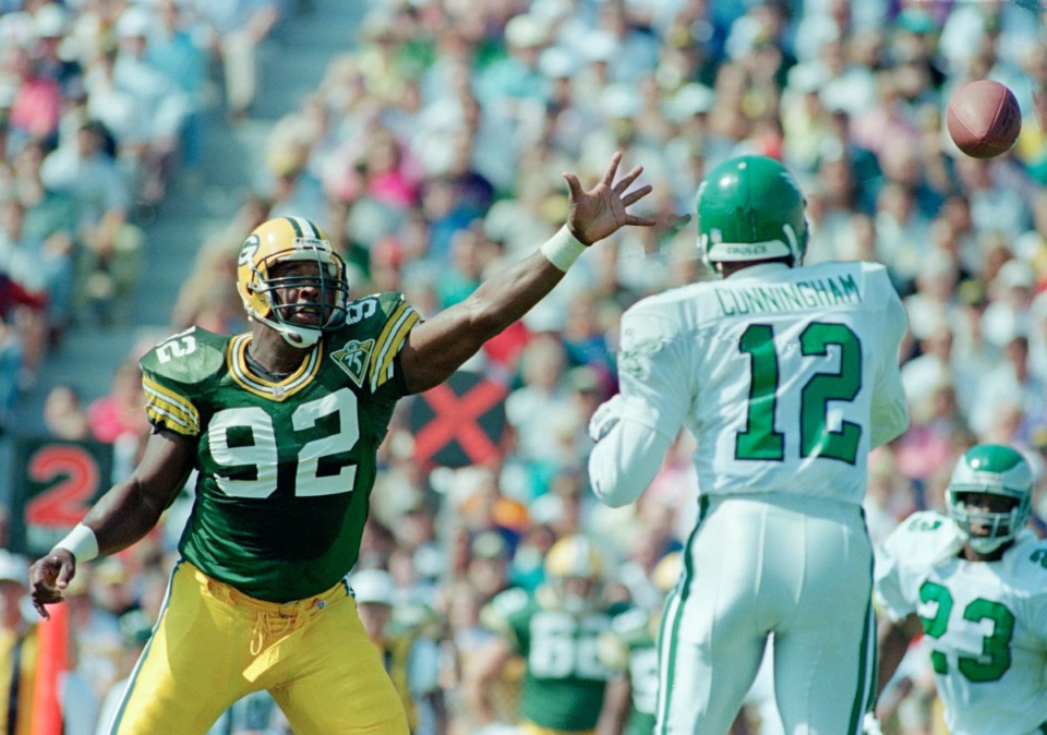 <strong>Green Bay Packers' defensive end and former Philadelphia Eagles' Reggie White (92) puts pressure on Eagles quarterback Randall Cunningham (12) during the first half, Sept. 12, 1993, in Green Bay.</strong> (Jerry Redfern/AP Phot)