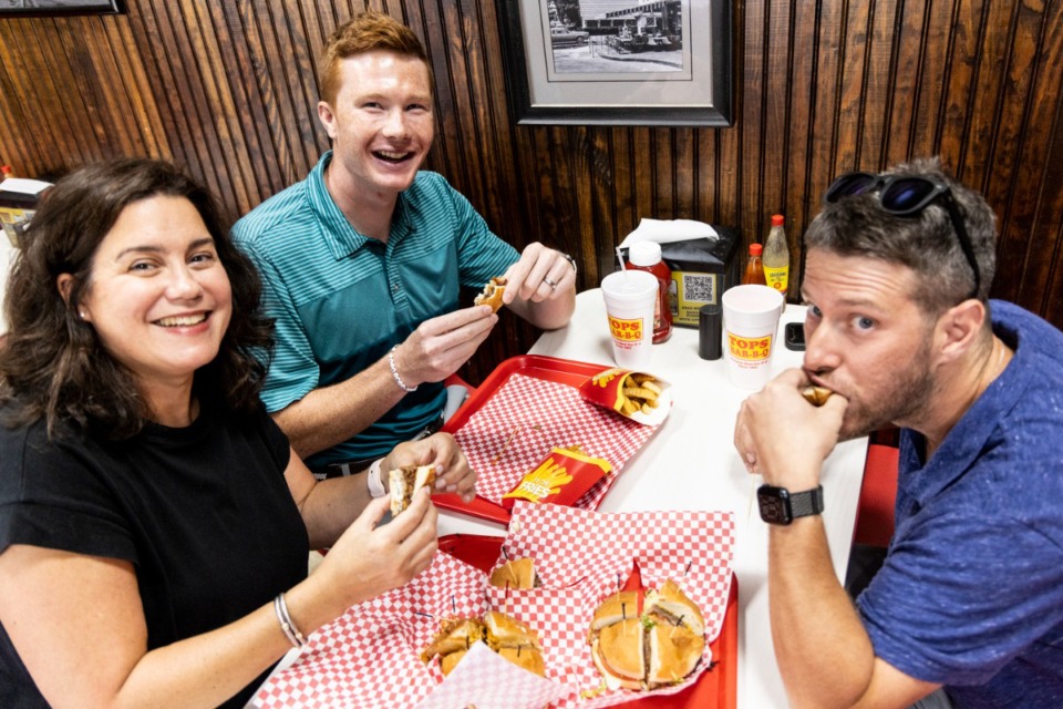 <strong>Jennifer Chandler (left) King Jemison, center, and Samuel Hardiman, right, taste test new burgers at Tops Bar-B-Q on Poplar.</strong>&nbsp;(Brad Vest/Special to The Daily Memphian)