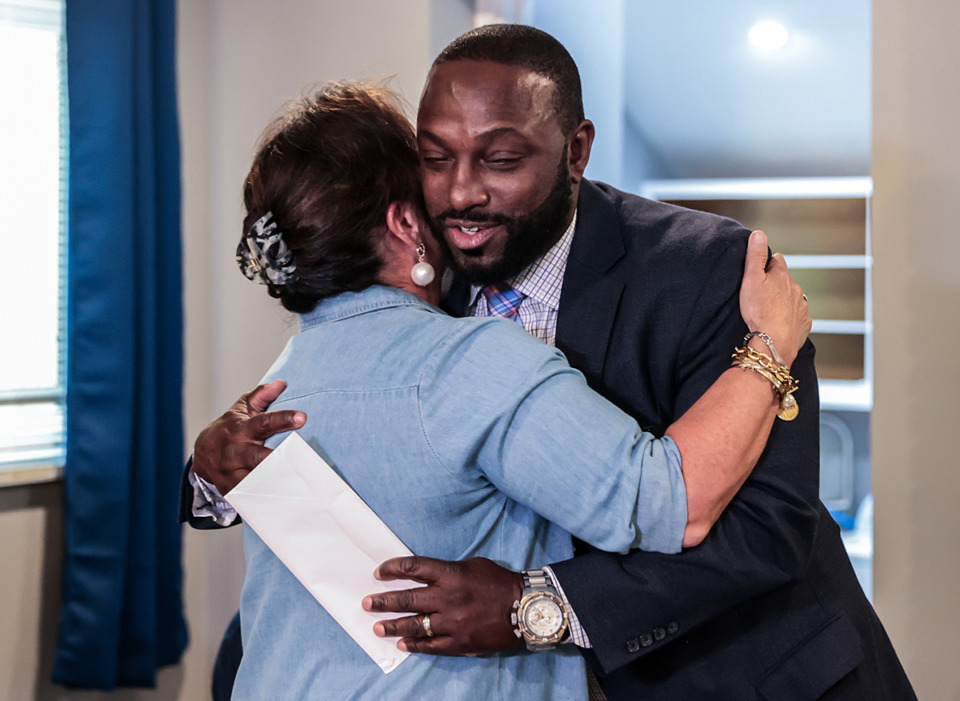 <strong>DeAndre Brown, co-founder of Lifeline to Success, hugs Dawn Welch Kinard at a Thursday, Aug. 29, press conference. Kinard donated&nbsp;the deed to the Frayser house to Lifeline.</strong> (Patrick Lantrip/The Daily Memphian)