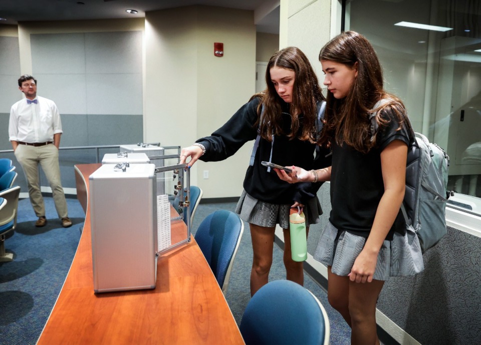 <strong>Hutchison School students grab their cell phones after school Friday, Aug. 30. The school instituted a locking box system where all students put their phones in the morning, then pick up at the end of the day.</strong> (Mark Weber/The Daily Memphian)