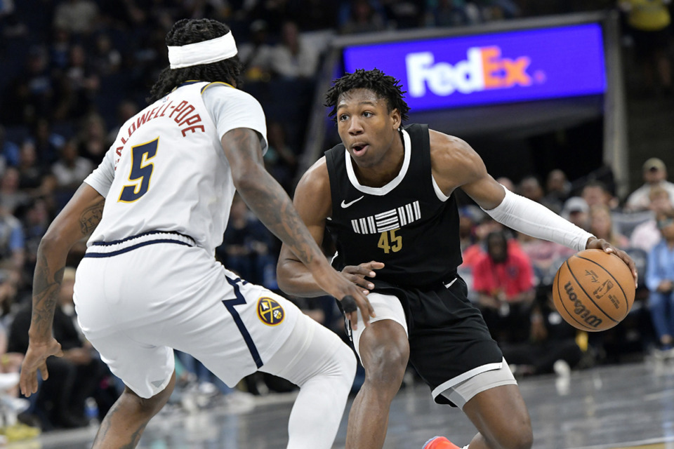 <strong>The Memphis Grizzlies&rsquo; GG Jackson (45) handles the ball against Denver Nuggets guard Kentavious Caldwell-Pope (5) in the first half of an NBA basketball game April 14 in Memphis.</strong> (Brandon Dill/AP file)