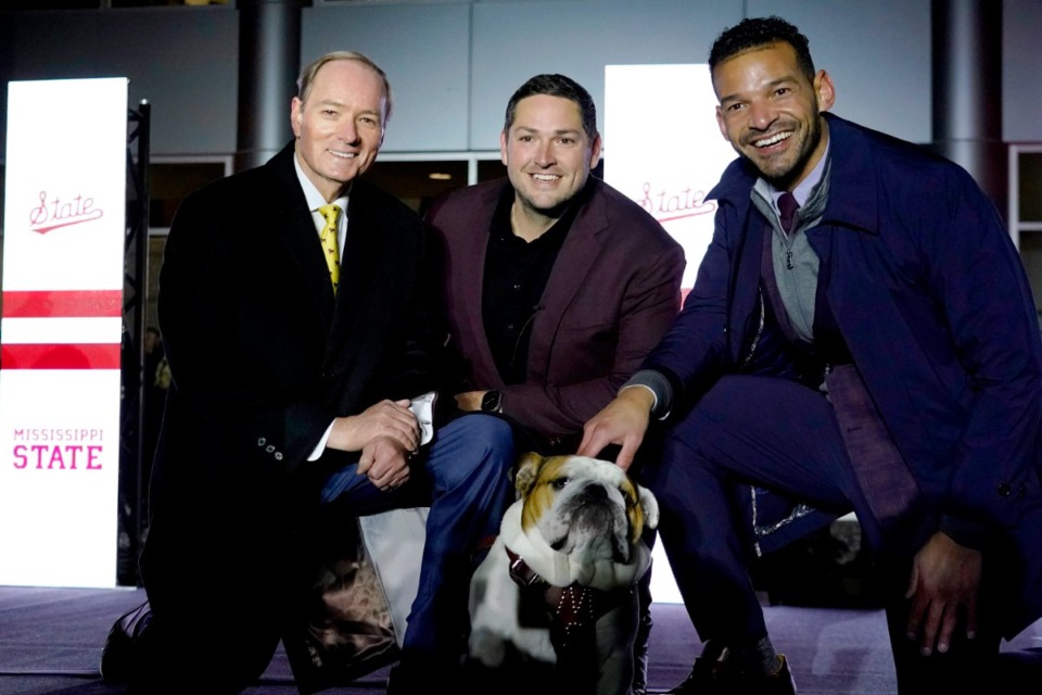 <strong>New Mississippi State football coach Jeff Lebby (center) posed with university president Mark Keenum (left), athletic director Zac Selmon (right), and the school's mascot bulldog Dak after a rally in Starkville, Miss.</strong> (Rogelio V. Solis/AP file)