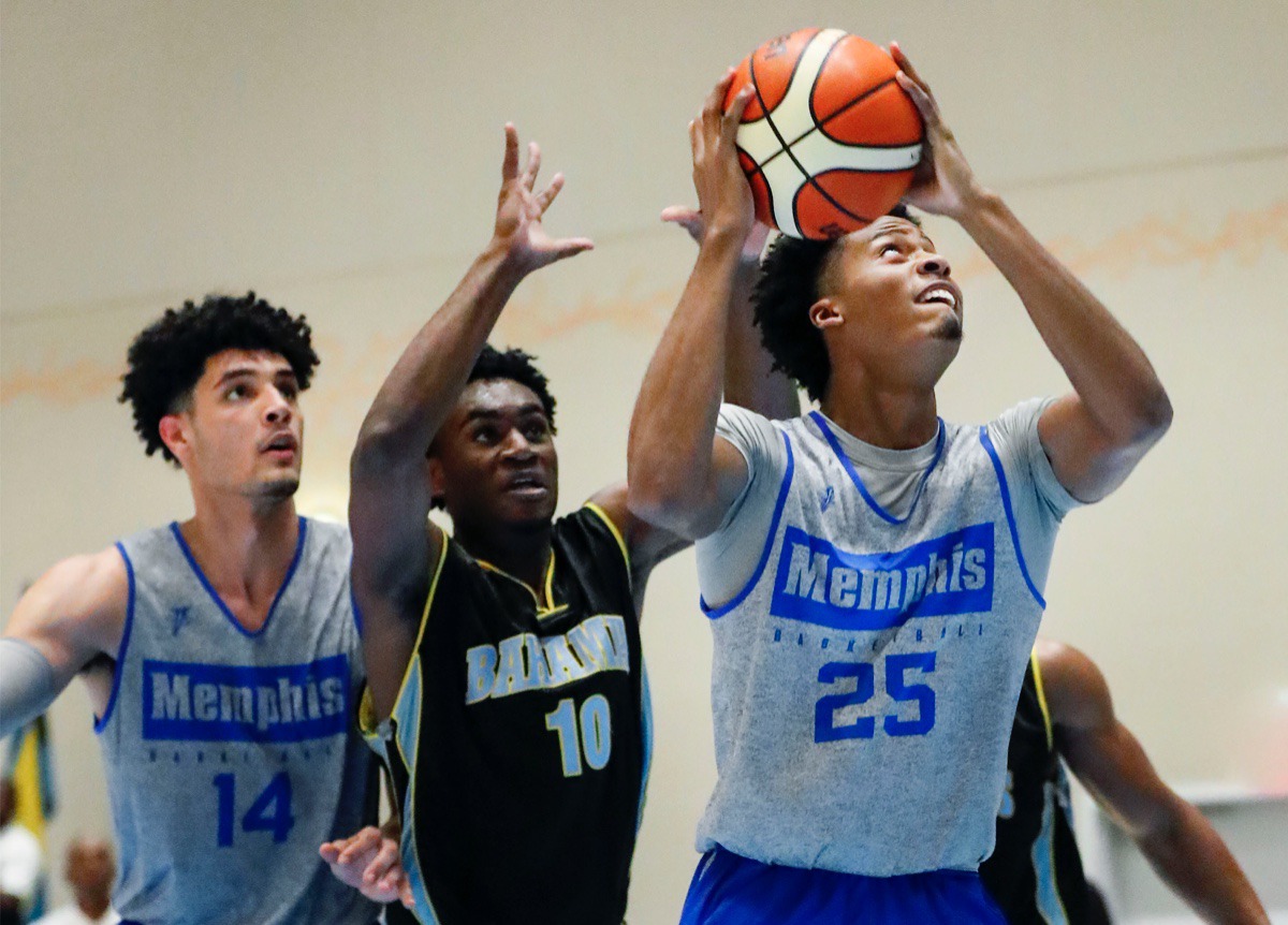 <strong>Tigers forward Jayden Hardaway (right) drives for a layup against NPBA Select defender Ziv Basden (middle) as teammate Isaiah Maurice (left) looks on Thursday in the Bahamas.</strong> (Mark Weber/Daily Memphian)