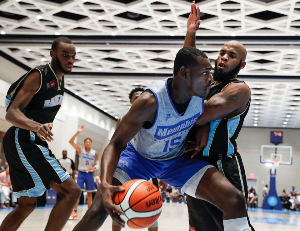 <strong>Memphis Tigers forward Lance Thomas (middle) drives the lane against NPBA Select defender Devon Ferguson (right) during acton in their exhibition game in Nassau, Bahamas, Thursday, August 15, 2019.</strong> (Mark Weber/Daily Memphian)