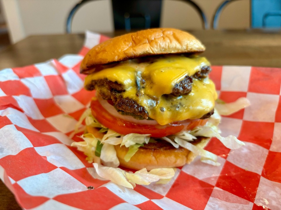 <strong>At Bain Barbecue, you get your choice of one or two smashed and crisped Home Place Pastures beef patties, covered in melted American cheese, teetering atop shredded iceberg lettuce, tomato, onion and slightly sweet bread and butter pickles.</strong> (Joshua Carlucci/Special to The Daily Memphian)