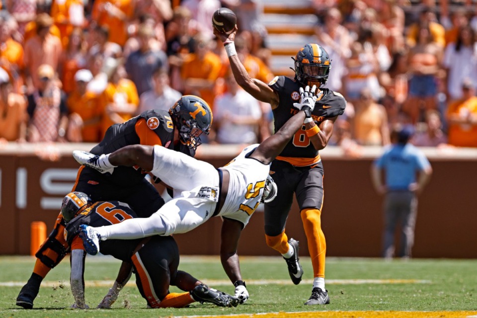 <strong>Tennessee quarterback Nico Iamaleava (8) throws a pass as he's pressured by Chattanooga defensive tackle Jamarr Jones (57) during the first half of an NCAA college football game Saturday, Aug. 31, 2024, in Knoxville, Tenn.</strong> (AP Photo/Wade Payne)