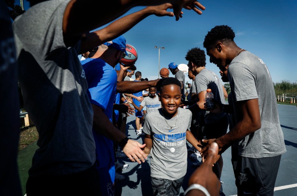 <strong>Memphis Tigers players cheer on local youth after taking part in a basketball camp in the Bozine Town area of Nassau, Bahamas, Aug. 16, 2019.</strong> (Mark Weber/Daily Memphian)