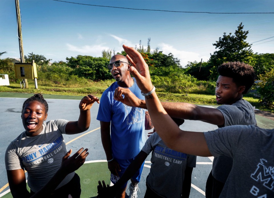 <strong>Memphis Tigers head coach Penny Hardaway (middle) cheers with his payers and local youth during a basketball camp in the Bozine Town area of Nassau, Bahamas, Aug. 16, 2019.</strong> (Mark Weber/Daily Memphian)