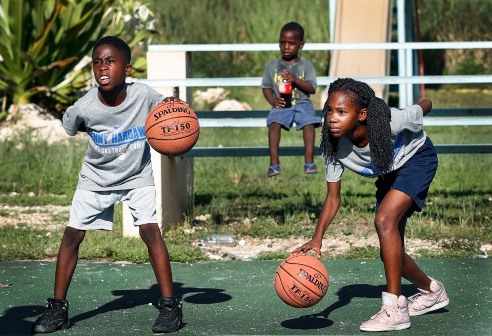 <strong>Raynia Russell, 11, (left) performs dribbling drills with along with fellow campers during a basketball camp with Memphis Tigers coaches and players in the Bozine Town area of Nassau, Bahamas, Aug. 16, 2019.</strong> (Mark Weber/Daily Memphian)