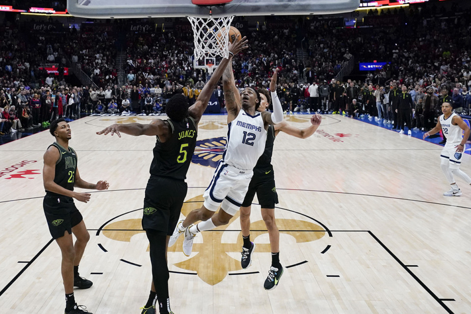 <strong>Memphis Grizzlies guard Ja Morant (12) goes to the basket between New Orleans Pelicans forward Herbert Jones (5) and guard Dyson Daniels for the game winning shot at the buzzer in the second half of an NBA basketball game in New Orleans, Tuesday, Dec. 19, 2023. The Grizzlies won 115-113.</strong> (Gerald Herbert/AP Photo file)