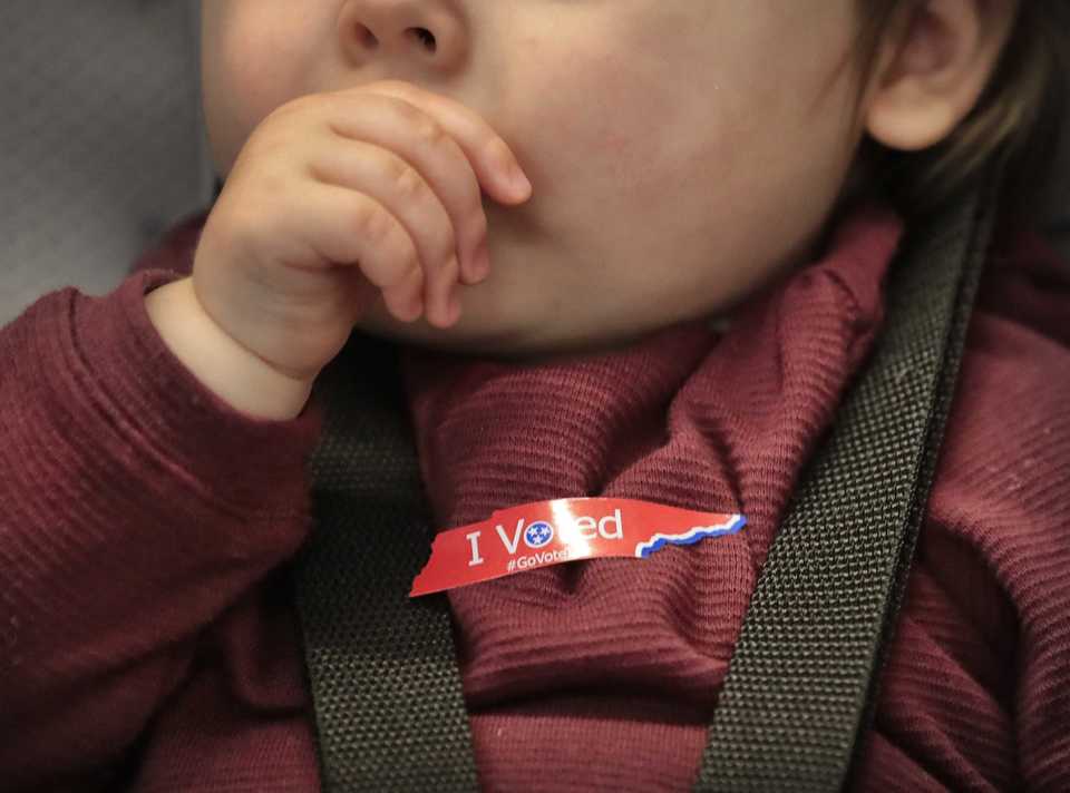 <strong>One-year-old Olivia Holt gets a sticker, too, for joining Anna Holt as she cast her ballot at the Agricenter during the first day of early voting in Shelby County on Oct. 17, 2018.</strong> (Jim Weber/Daily Memphian)