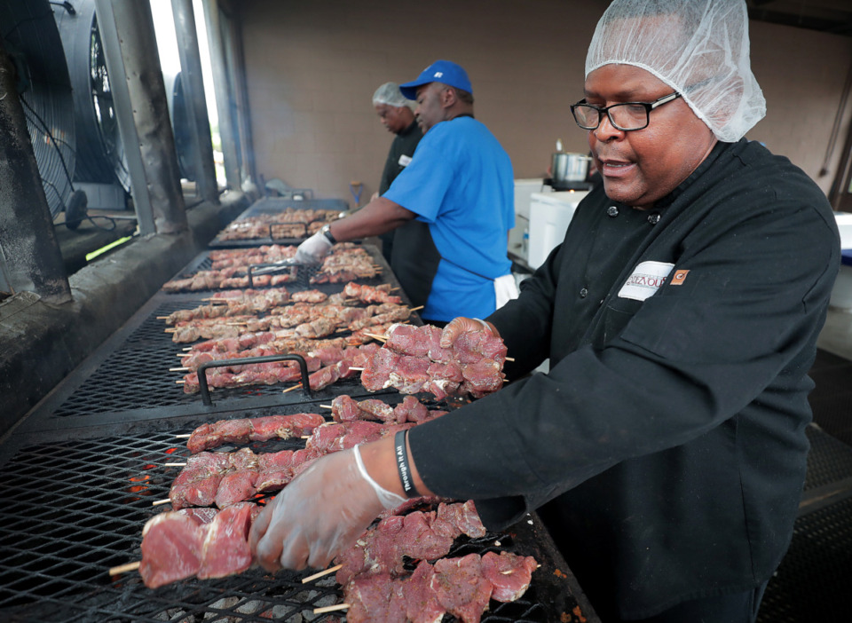 <strong>Anthony Williams (right) grills pork kabobs as volunteers hurry to finish preparations on Friday, May 10, 2019, for the annual Greek Festival at Annunciation Greek Orthodox Church.</strong>&nbsp;(The Daily Memphian file)