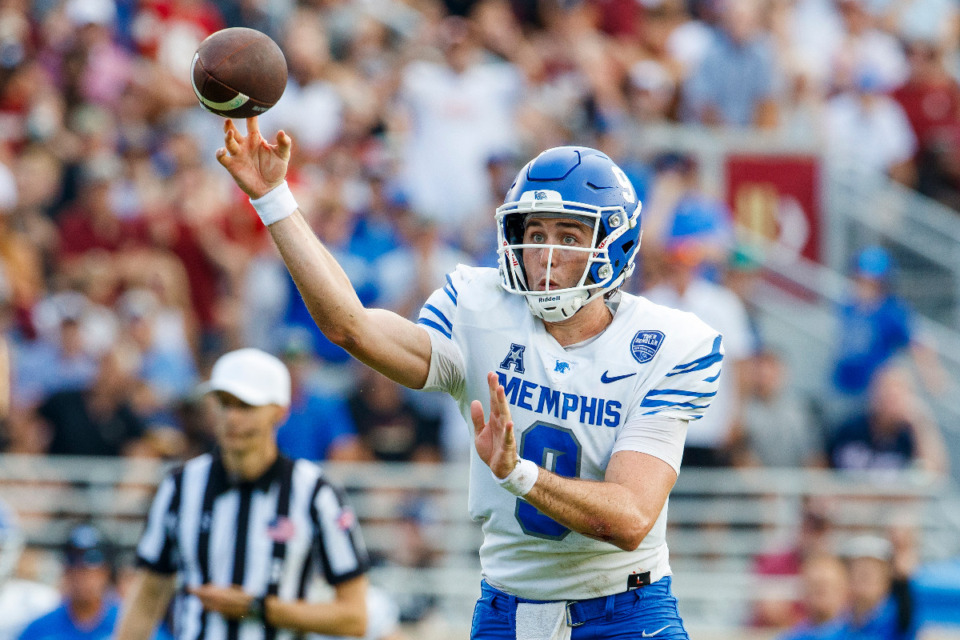 <strong>Memphis quarterback Seth Henigan (9) throws a touchdown pass during the first half of an NCAA college football game against Florida State Sept. 14 in Tallahassee, Fla.</strong> (Colin Hackley/AP file)