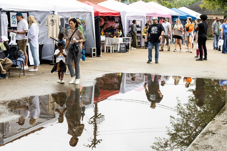 <strong>After two days of rain, visitors to the Cooper-Young Festival had to sidestep puddles.</strong> (Brad Vest/Special to The Daily Memphian)