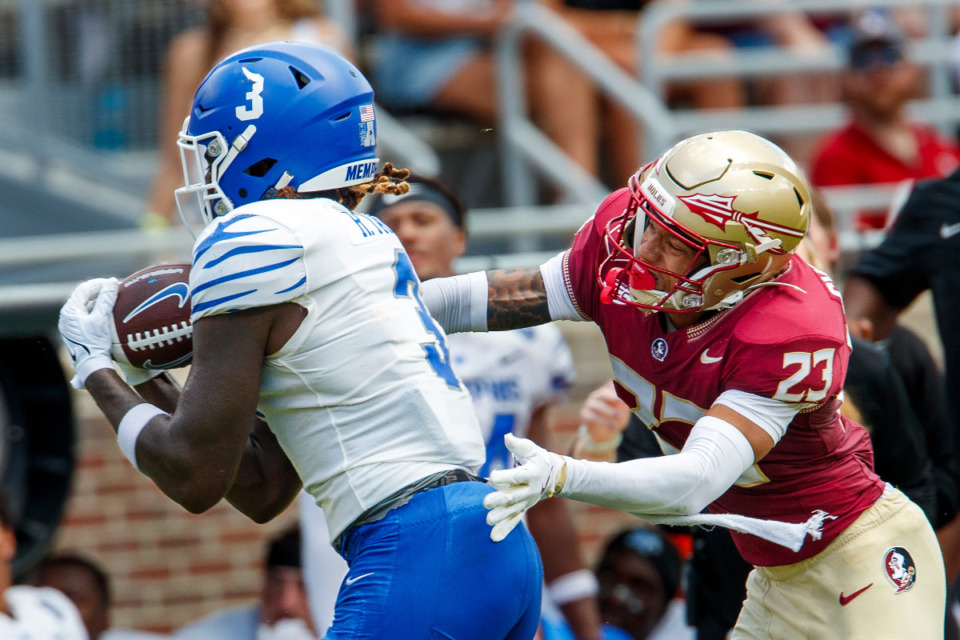 <strong>Memphis wide receiver Roc Taylor (3) pulls a pass in as Florida State defensive back Fentrell Cypress II (23) defends during the first half of an NCAA college football game Sept. 14 in Tallahassee, Fla.</strong> (Colin Hackley/AP file)