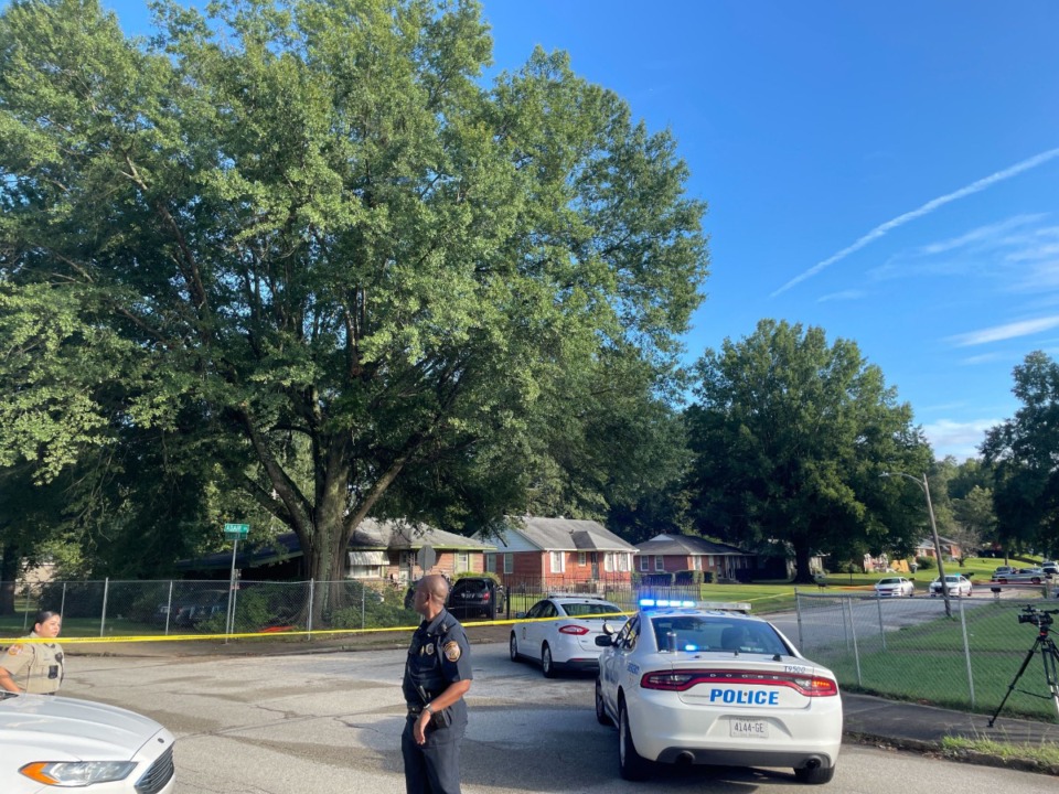 <strong>Law enforcement officers block off the intersection of Frayser Boulevard and Adair Drive, about a block north of where Memphis police say officers initiated the traffic stop of a stolen car. While fleeing arrest on foot, one of two men in the car shot at officers and was killed after officers fired back, police say.</strong> (Laura Testino/The Daily Memphian)