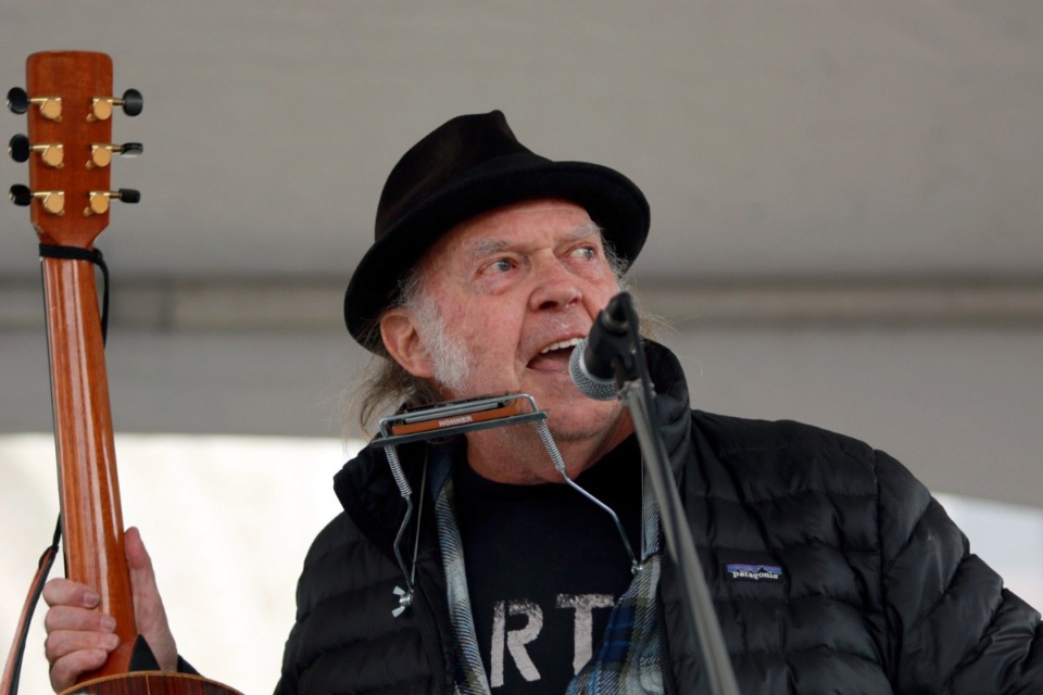 <strong>Rock legend Neil Young performs during a rally against the destruction of old-growth forests on the front lawn of the legislature in Victoria, British Columbia, on Saturday, Feb. 25, 2023.</strong> (Chad Hipolito/The Canadian Press via AP)