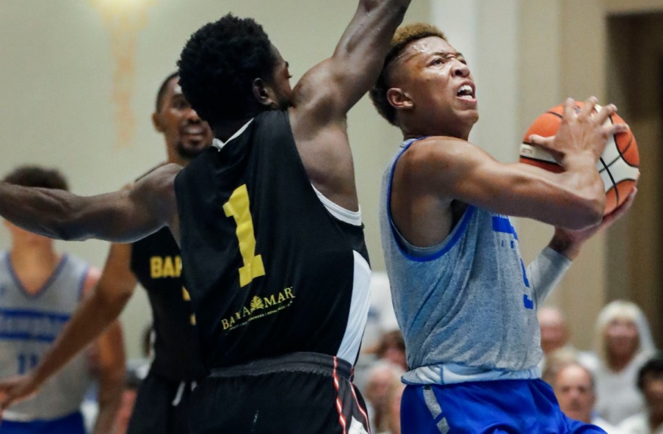 <strong>Memphis Tigers guard Boogie Ellis (right) drives the lane against Bahamas National Team defender Jackson Jacob (left) during action in their exhibition game in Nassau, Bahamas, Saturday, August 17, 2019.</strong> (Mark Weber/Daily Memphian)