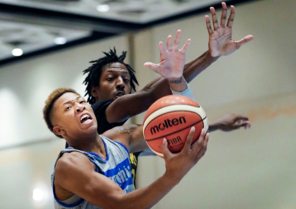<strong>Memphis Tigers guard Boogie Ellis (front) drives the basket against Bahamas National Team defender Donrad Knowles (back) during action in their exhibition game in Nassau, Bahamas, Saturday, August 17, 2019.</strong> (Mark Weber/Daily Memphian)