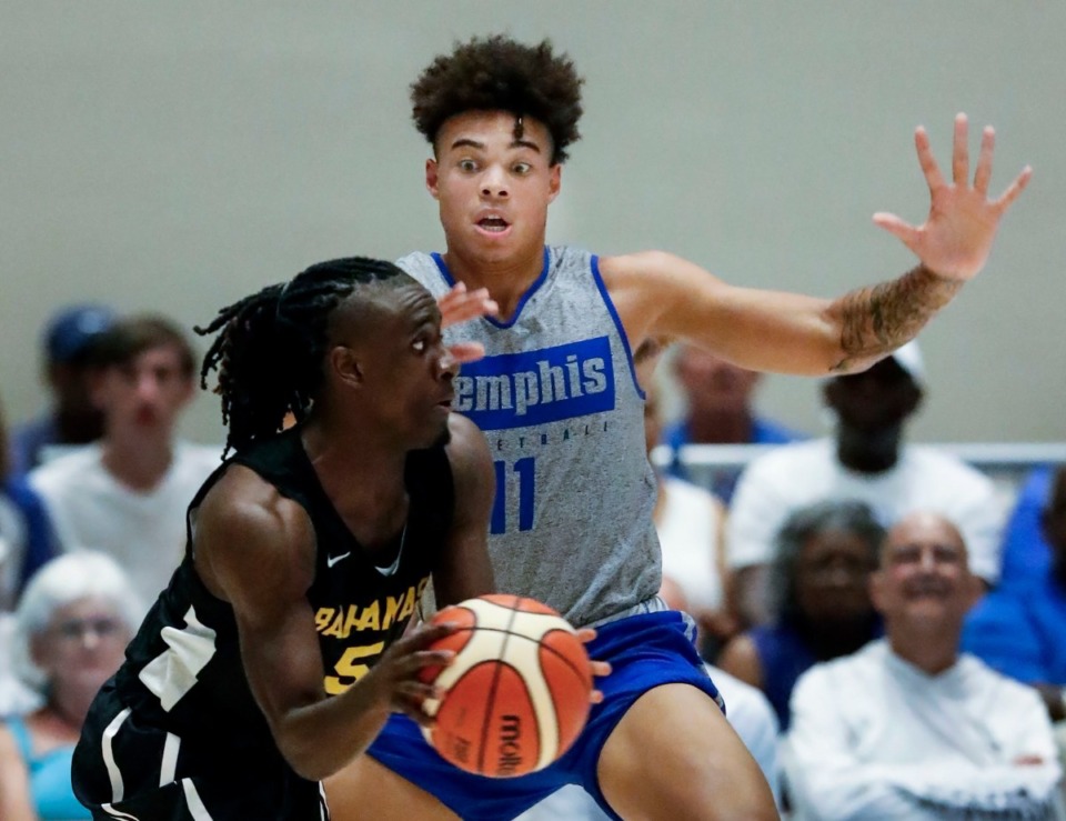 <strong>Memphis Tigers defender Lester Quinones (right) applies defensive pressure to Bahamas National Team guard Godfrey Rolle Jr. (left) during action in their exhibition game in Nassau, Bahamas, Saturday, August 17, 2019.</strong> (Mark Weber/Daily Memphian)