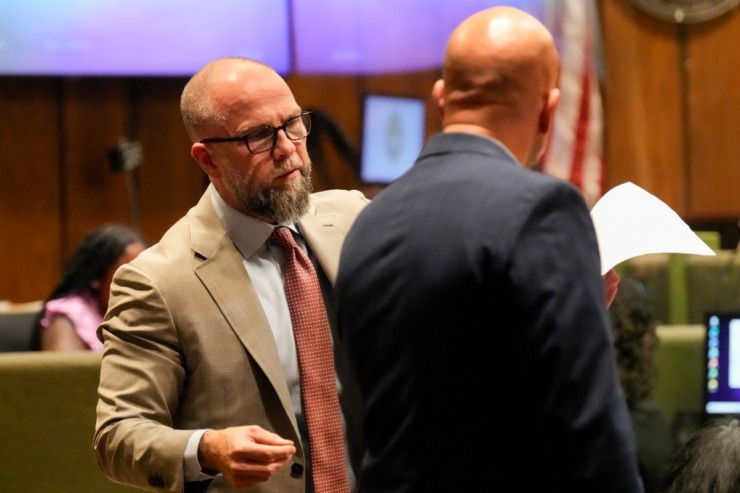 <strong>Defendant Justin Johnson's attorney Luke Evans, left, speaks with Paul Hagerman, Shelby County deputy district attorney, right, during Johnson's trial for the murder of rapper Young Dolph, Tuesday, Sept. 24, 2024, in Memphis, Tenn.</strong> (AP Photo/George Walker IV, Pool)