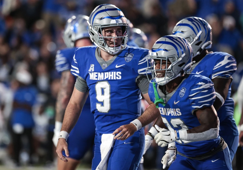 <strong>University of Memphis quarterback Seth Henigan (9) laughs with Brandon Thomas (22) after a touchdown during a Sept. 28, 2024 game against MTSU.</strong> (Patrick Lantrip/The Daily Memphian)