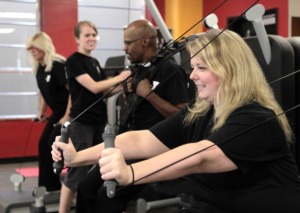 <strong>The Fogelman YMCA, seen here with employee Brenna Walker working out with co-workers on the kinesis functional strength station, received $200,000 from Plough Foundation recently for a renovation that will begin in November.</strong> (Daily Memphian file)