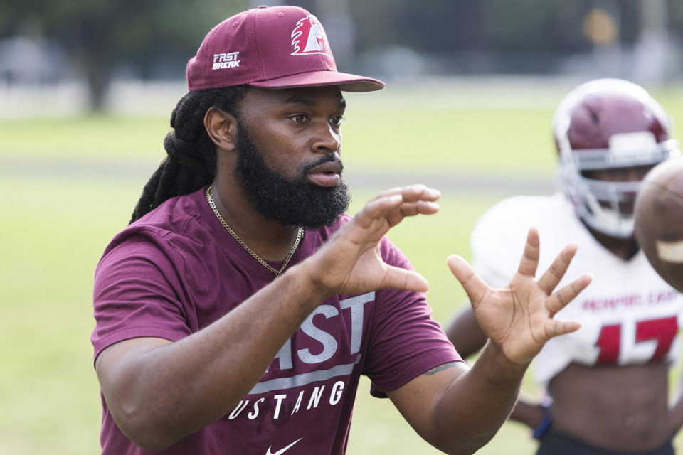 <strong>Coach Greg Moore participates in the Mustangs&rsquo; football practice at East High.</strong> (Brad Vest/Special to The Daily Memphian)