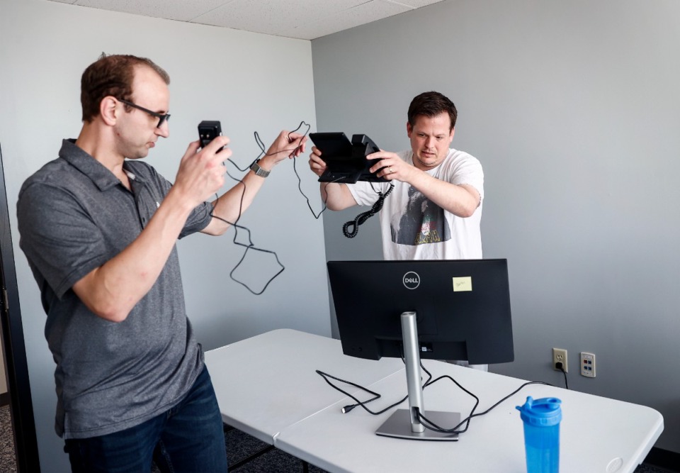 <strong>West Tennessee Legal Services attorneys Cole Adams (left) and Garth Carson set up equipment in their new offices on Tuesday, Oct. 1, 2024.</strong> (Mark Weber/The Daily Memphian)