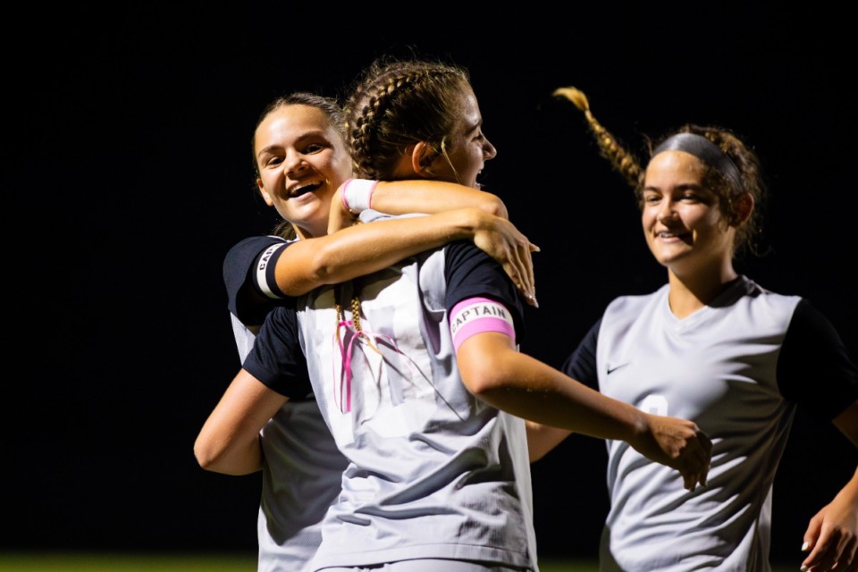 <strong>McKlain Jones (left) and Scarlett Cowles (right) congratulate Ellett Smith on her goal at Collierville Thursday, October 3, 2024.</strong> (Benjamin Naylor/The Daily Memphian)