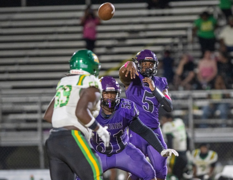 <strong>Southwind quarterback Kelvin Perkins (5) passes over the Central defensive line on Friday, Oct. 4. Southwind won the conference game 35-20 to improve to 6-1.</strong> (Greg Campbell/Special to The Daily Memphian)