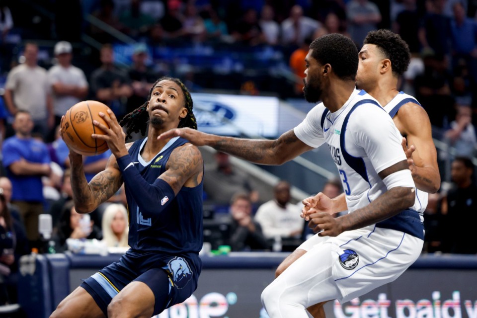 <strong>Memphis Grizzlies guard Ja Morant, left, drives past Dallas Mavericks forward Naji Marshall, front right, during the first half of an NBA preseason basketball game in Dallas, Monday, Oct. 7, 2024.</strong> (Gareth Patterson/AP)