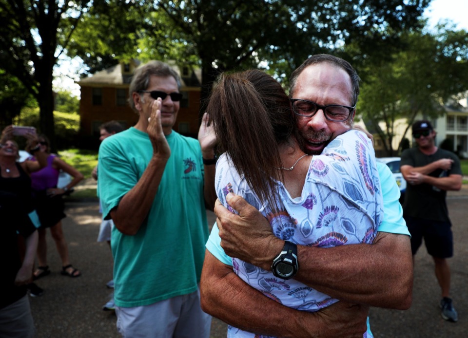 <strong>Golfer Doug Barron hugs his wife Leslie, who surprised him with a large gathering of friends, family and firefighters outside of their Germantown home as Barron returned home Monday, Aug. 19, after winning the Dick's Sporting Goods Open.</strong> (Patrick Lantrip/Daily Memphian)
