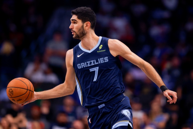 Memphis Grizzlies forward Santi Aldama brings the ball down court during the first half of an NBA preseason basketball game against the Dallas Mavericks in Dallas, Monday, Oct. 7, 2024. (AP Photo/Gareth Patterson)