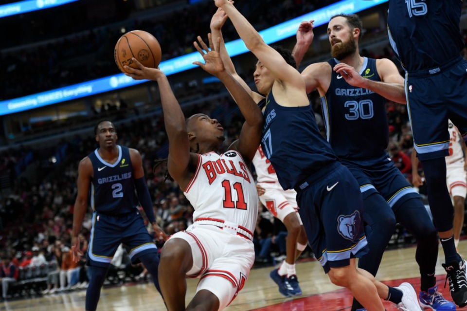 <strong>Chicago Bulls' Ayo Dosunmu (11) looks to shoot against Memphis Grizzlies' Yuki Kawamura (17) and Jay Huff (30) during the first half of an NBA preseason basketball game in Chicago, Saturday, Oct. 12, 2024.</strong> (Paul Beaty/AP)