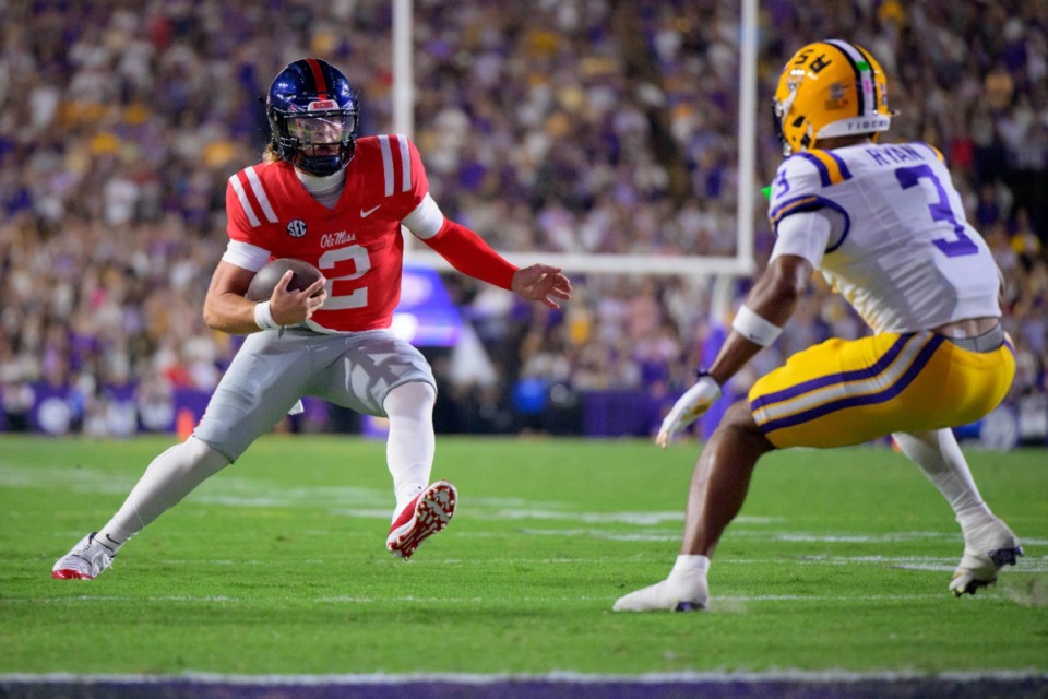 <strong>Mississippi quarterback Jaxson Dart (2) runs against LSU safety Sage Ryan (3) during the first half of an NCAA college football game in Baton Rouge, La., Saturday, Oct. 12, 2024.</strong> (Matthew Hinton/AP)