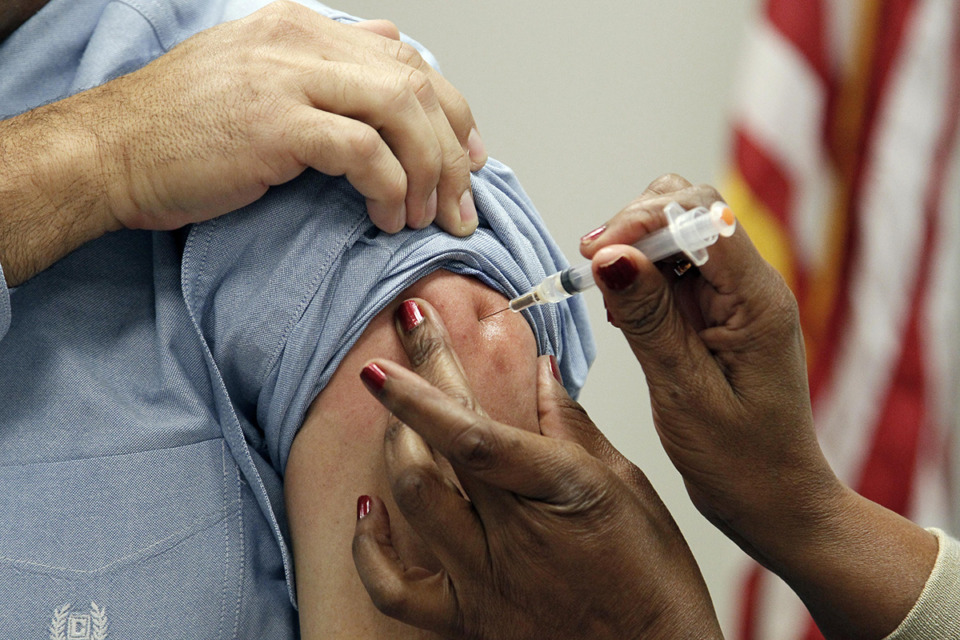 <strong>A one-day, statewide vaccination event will take place on Tuesday, Oct. 15 as part of the Tennessee Department of Health&rsquo;s &ldquo;Fight Flu TN&rdquo; initiative. Dr. Paul Byers, deputy state Epidemiologist for the Mississippi Department of Health left, is given an intramuscular shot of flu vaccine Wednesday, Oct. 17, 2012 in Jackson, Miss. The seasonal flu vaccine is recommended for anyone age six months and older.</strong> (Rogelio V. Solis/AP Photo file)