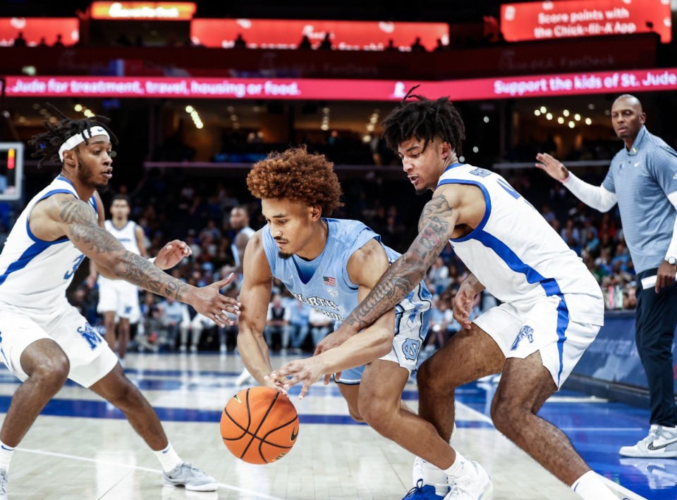 <strong>University of Memphis teammates Colby Rogers (left) and P.J. Haggerty (right) apply pressure to North Carolina guard Seth Trimble (middle) on Oct. 15, 2024.</strong> (Mark Weber/The Daily Memphian)