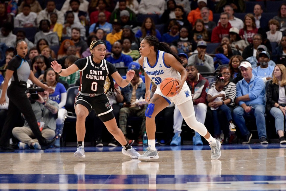 <strong>Memphis forward Alasia Smith (30) handles the ball against South Carolina guard Te-Hina Paopao (0) during the Hoops for St. Jude Tip Off Classic NCAA college basketball exhibition game Tuesday, Oct. 15, 2024, in Memphis, Tenn.</strong> (AP Photo/Brandon Dill)