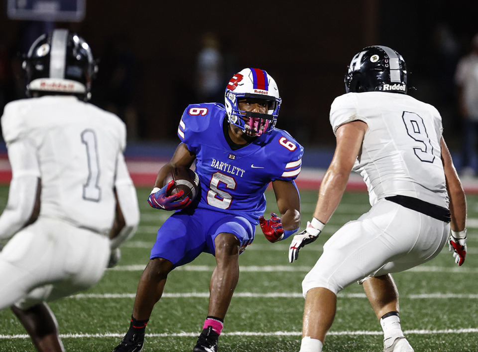 <strong>Bartlett running back Geron Johnson, middle, looks for a running lane against Houston during action Oct. 4.</strong> (Mark Weber/The Daily Memphian)